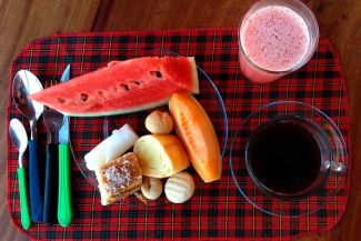 Frutas, pães e sucos no café da manhã